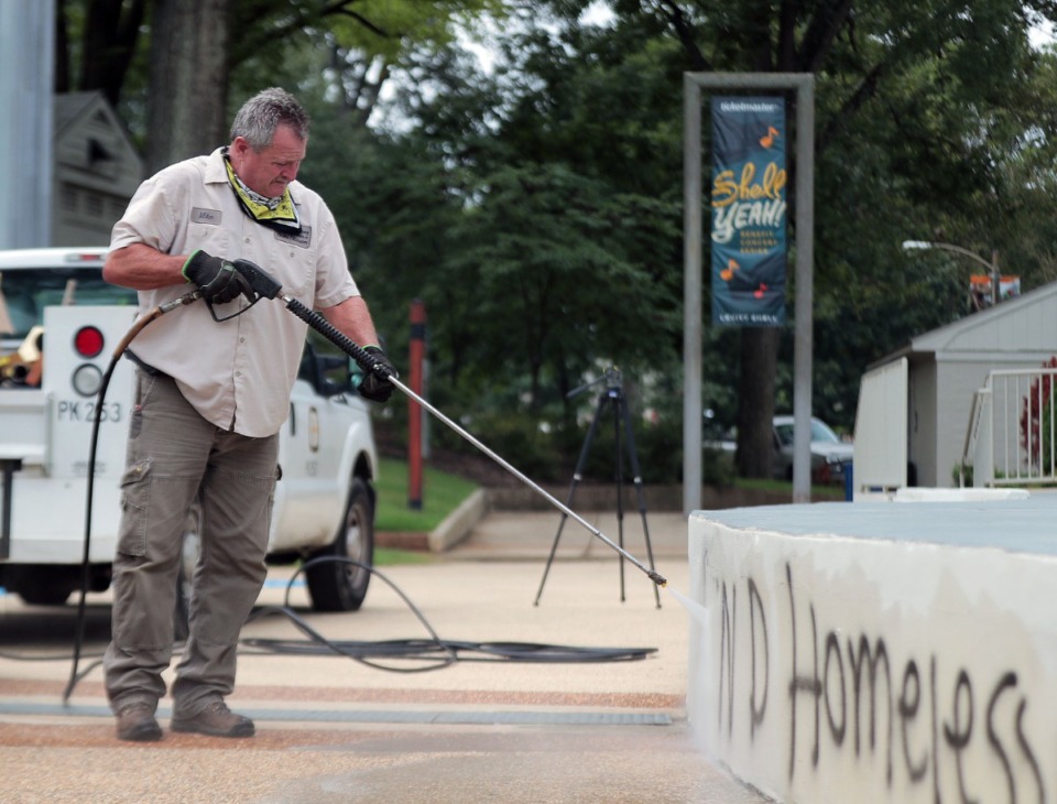 <strong>A city worker uses a pressure washer to remove graffiti from the Levitt Shell Sept. 1, 2020.</strong> (Patrick Lantrip/Daily Memphian)