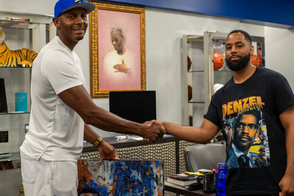 <strong>Memphis native Reggie Wayne (right) presents Tigers coach Penny Hardaway with a piece of artwork. Wayne grew up attending Hardaway&rsquo;s basketball camps.</strong> (Benji Aird/Airdography)
