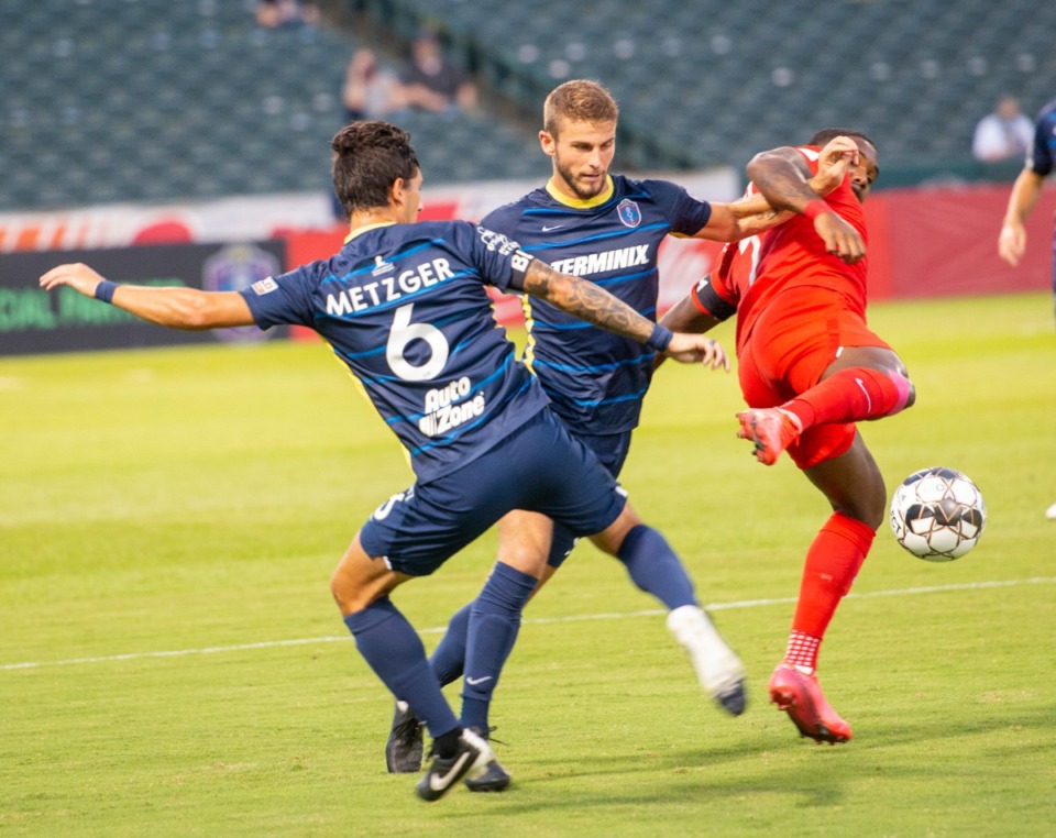 <strong>Memphis 901 FC&rsquo;s midfielders Dan Metzger and Zack Carroll battle Birmingham Legion&rsquo;s Brian Wright during Saturday&rsquo;s match at AutoZone Park. Memphis and Birmingham played to a 1-1 tie.</strong>(Greg Campbell/Special to Daily Memphian)