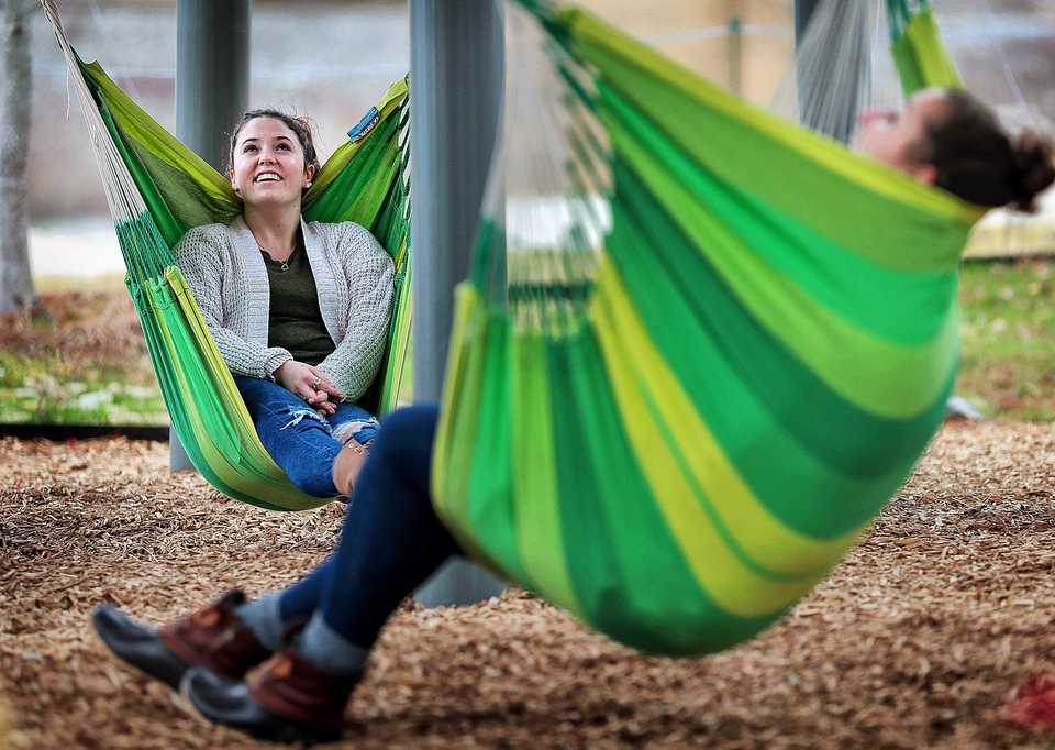 <strong>Harding University students Amanda McDuffie (left) and Haley Shearer relax at Mississippi River Park after cruising around Downtown on a pair of scooters during a road trip on Dec. 13, 2018. One month after its opening, Mississippi River Park is getting good traffic due in part to its proximity to the Tennessee Welcome Center.</strong> (Jim Weber/Daily Memphian)