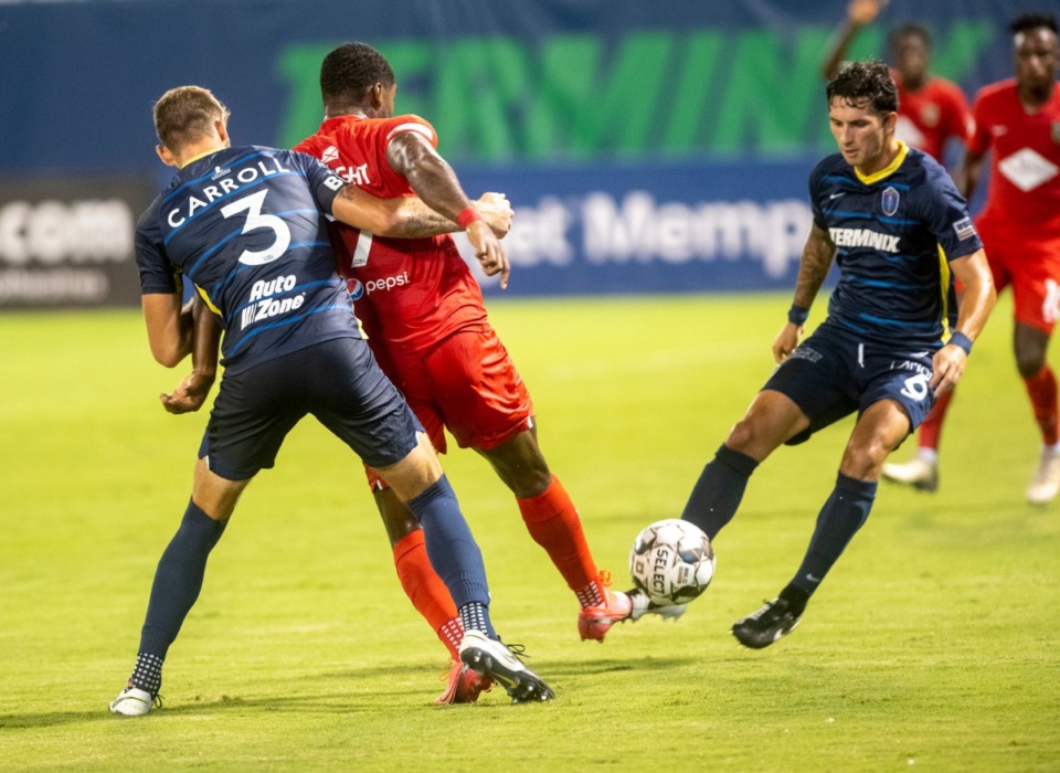 <strong>Memphis 901 Zach Carroll reaches around Birmingham Legion&rsquo;s Brian Wright as Dan Metzger kicks around during Saturday, September 5, 2020 match at AutoZone Park.</strong> (Greg Campbell/Special to Daily Memphian)