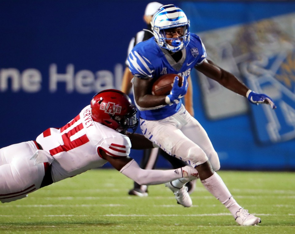<strong>University of Memphis running back Kylan Watkins (17)breaks a tackle from Arkansas State linebacker Fred Harvey(24) on his way to a touchdown during the Tigers' home opener at the Liberty Bowl Sept.5, 2020.</strong> (Patrick Lantrip/Daily Memphian)