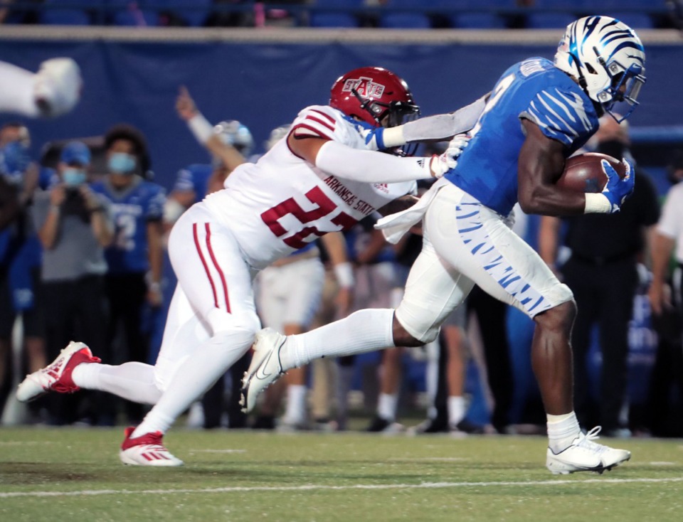 <strong>University of Memphis running back Rodrigues Clark (2) breaks a tackle from Arkansas State linebacker Caleb Bonner (22) on his way to a touchdown during the Tigers' home opener at the Liberty Bowl Sept.5, 2020.</strong> (Patrick Lantrip/Daily Memphian)