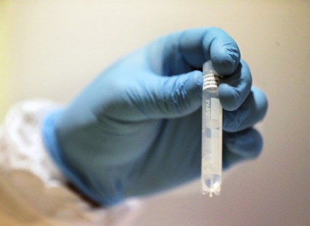 <strong>A vial from a cornavirus testing kit is held up at a University of Tennessee Health Science Center lab Sept. 1, 2020.</strong> (Patrick Lantrip/Daily Memphian)
