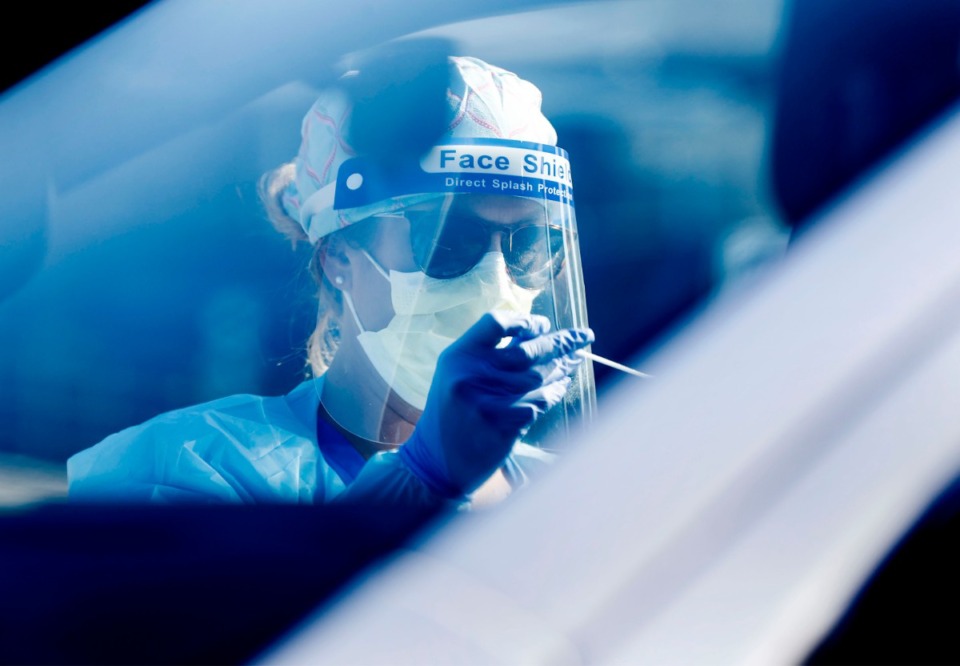 <strong>Registered nurse Holly Cote administers COVID-19 testing swabs at a Baptist Memorial Hospital-Memphis drive-thru site on Thursday, June 18, 2020.</strong> (Mark Weber/Daily Memphian)