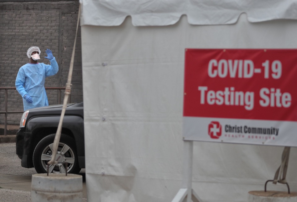 <strong>Will Jackson directs traffic as staff from Christ Community Health Services administer COVID-19 tests at a drive-thru tent behind their South Memphis clinic on March 21, 2020</strong>. (Jim Weber/Daily Memphian file)