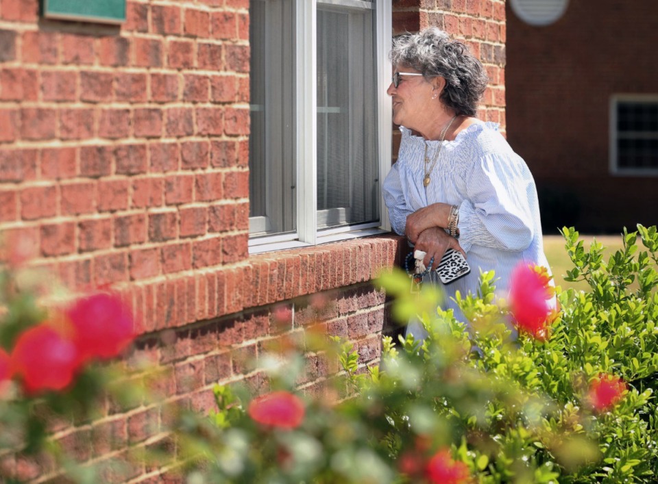 <strong>A family member visits a relative from outside Ave Maria Home in Bartlett.</strong> (Karen Pulfer Focht/Daily Memphian file)