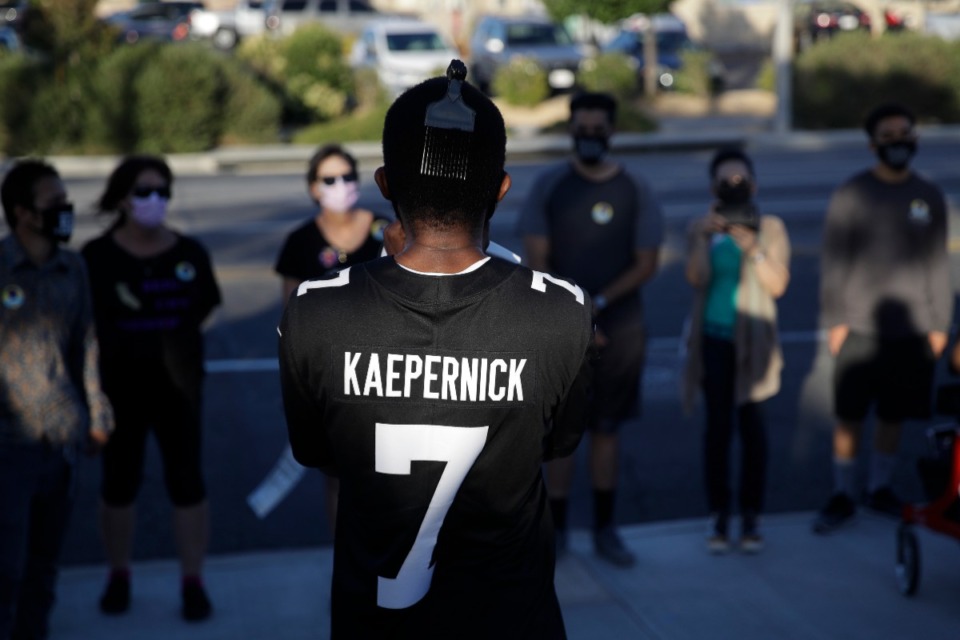 <strong>A demonstrator wears a Colin Kaepernick jersey at a Juneteenth demonstration June 19, 2020, in Palmdale, Calif. Nike released its own version of the jersey last week and it sold out within seconds.</strong> (Marcio Jose Sanchez/AP file)