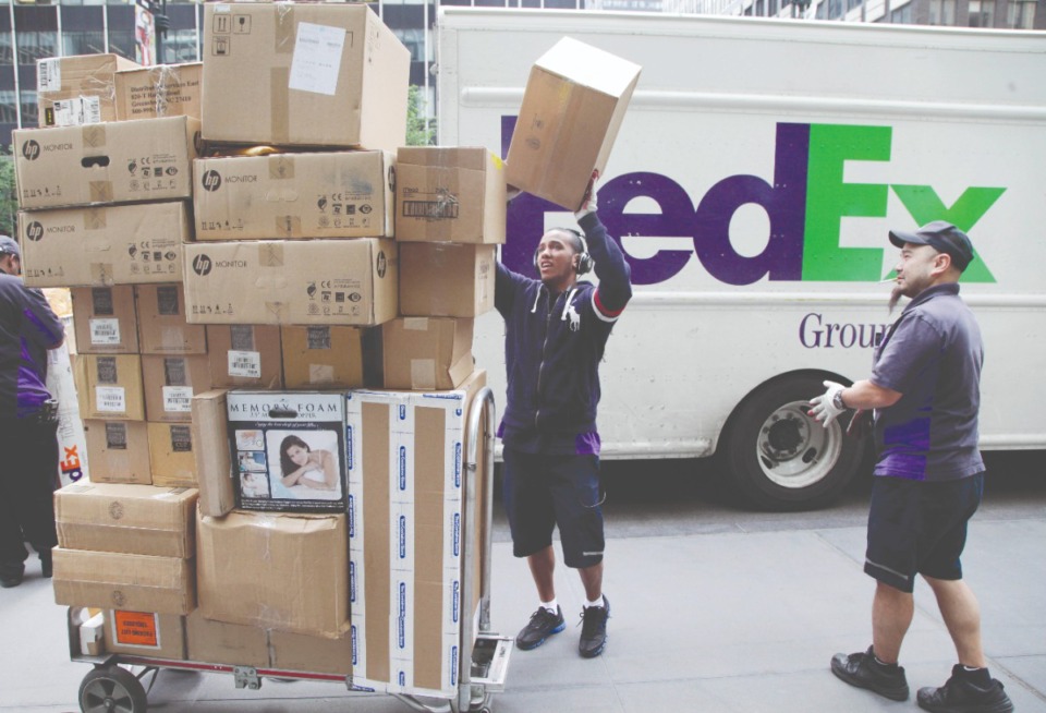 <strong>Average daily package volumes at FedEx Express and FedEx Ground in the third quarter hit 17.8 million, up more than 3 million from a year ago.&nbsp;</strong>(Mark Lennihan/AP file)