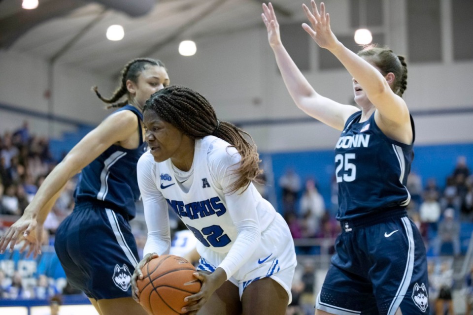<strong>Memphis forward Dulcy Fankam Mendjiadeu (center) grabs a rebound from Connecticut forward Olivia Nelson-Ododa, left, and Connecticut forward Kayla Irwin (25) in the second half of an NCAA college basketball game Tuesday, Jan. 14, 2020, in Memphis.</strong> (Nikki Boertman/AP)