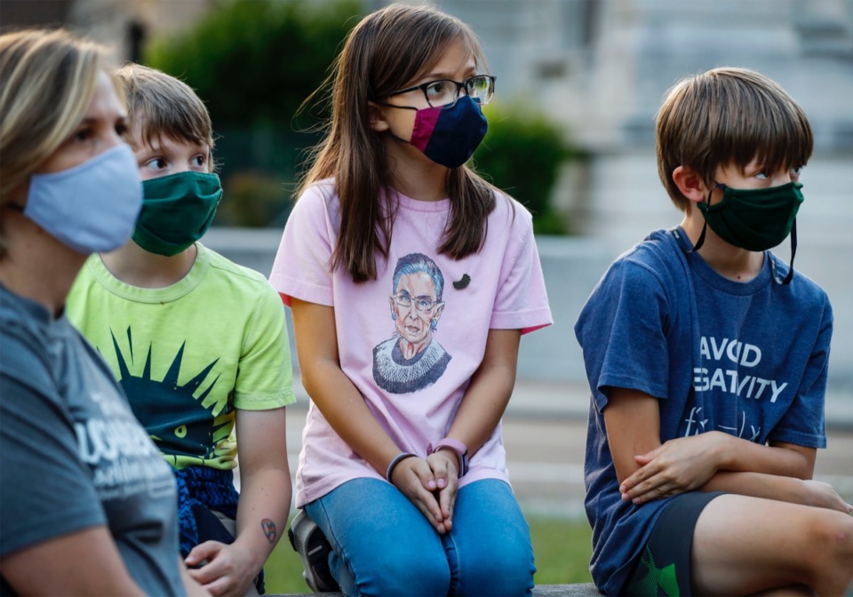 <strong>Scarlet Nickele, 8 (middle), dons a T-shirt of the late Supreme Court Associate Justice Ruth Bader Ginsburg, while attending a memorial in her honor on Sept. 21, 2020, at the Judge D&rsquo;Army Bailey Courthouse.</strong> (Mark Weber/The Daily Memphian)
