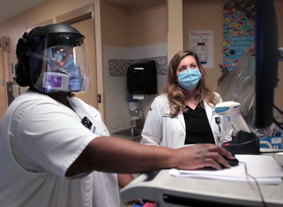 <strong>Dr. Amber Thacker (right) and Trishonda Scurlock go over patient data in a Regional One COVID ward Sept. 11, 2020</strong>. (Patrick Lantirp/Daily Memphian)