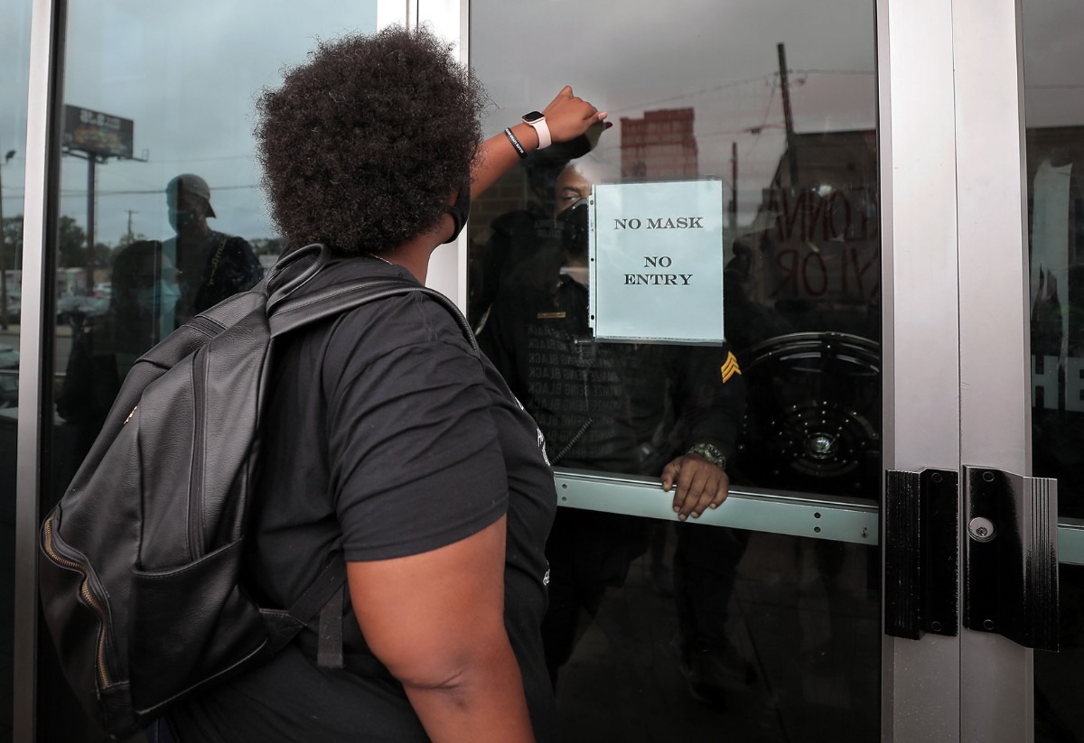 <strong>A group of Shelby County Sheriff's deputies in riot gear watch from behind locked doors as protesters gather outside the Shelby County Criminal Justice Center on Sept. 24.</strong> (Patrick Lantrip/Daily Memphian)