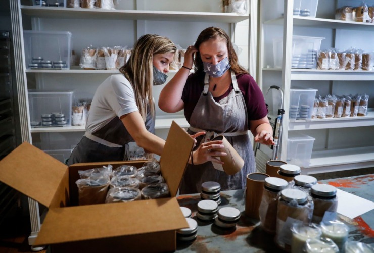 Re + New + All founder Lee Howard (left) and Kelsea Vaughn package candles for shipping on Sept. 15, 2020. The candle company offers employment and a brighter future for survivors of sex trafficking. (Mark Weber/The Daily Memphian)