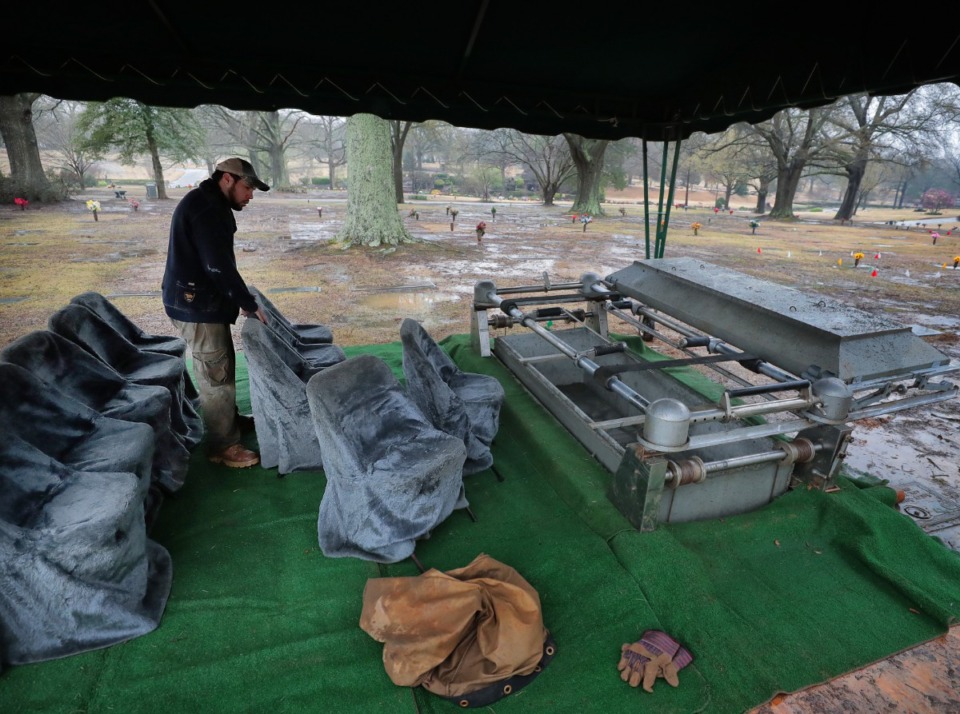 <strong>An employee with Southern Vault Co. prepares a burial site in the Memorial Park Cemetery earlier this year.</strong> (Jim Weber/Daily Memphian file)
