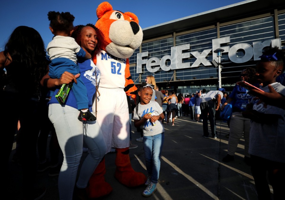 <strong>In this Oct. 4, 2018, file photo, Aaralyn Jeffries (center) poses with Pouncer the Tigers mascot outside the FedEx Forum.</strong> (Daily Memphian file)
