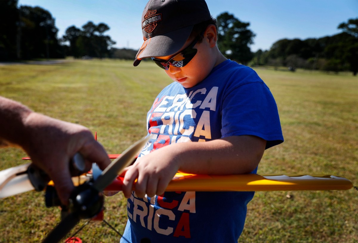 <strong>Taylor Pugh, 8, helps his grandfather as they gas up a Ringmaster airplane on Thursday, Oct. 1, 2020 at Audubon Park.</strong> (Mark Weber/The Daily Memphian)