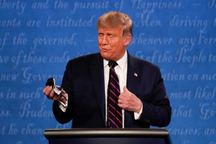 <strong>President Donald Trump holds out his face mask during the first presidential debate at Case Western University and Cleveland Clinic, in Cleveland, Ohio, Sept. 29, 2020.</strong> (Julio Cortez/AP)