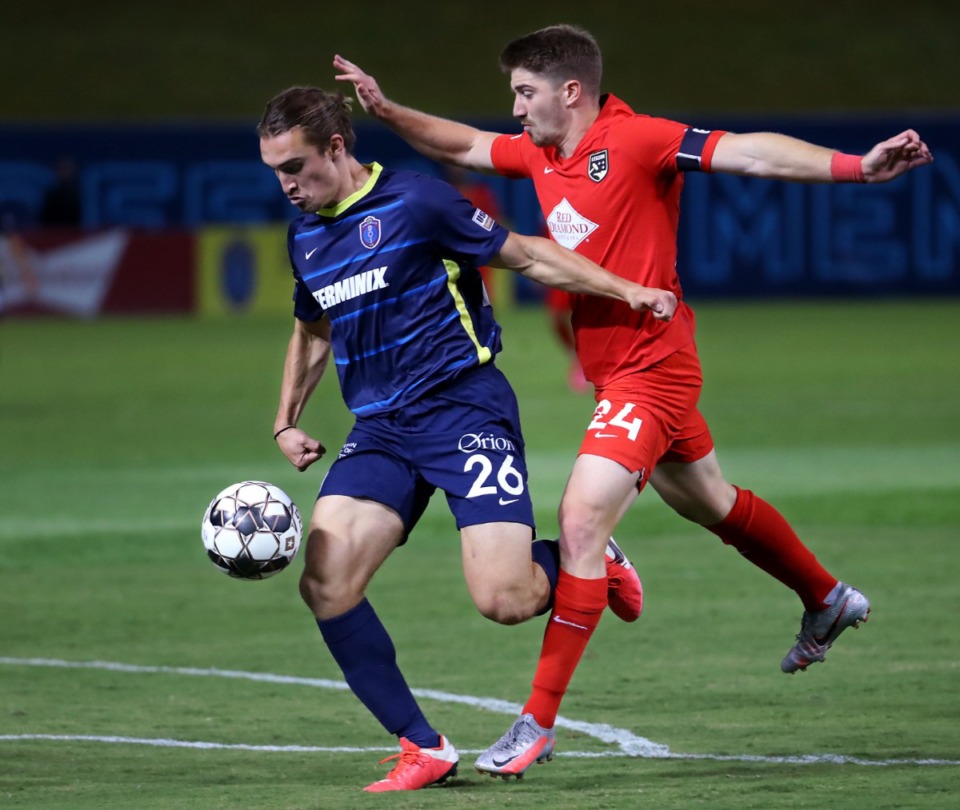<strong>Memphis 901 FC forward Cal Jennings (26) fights off a Birmingham Legion defender on his way to his second of three goal during a Oct. 3, 2020 game at AutoZone Park.</strong> (Patrick Lantrip/Daily Memphian)