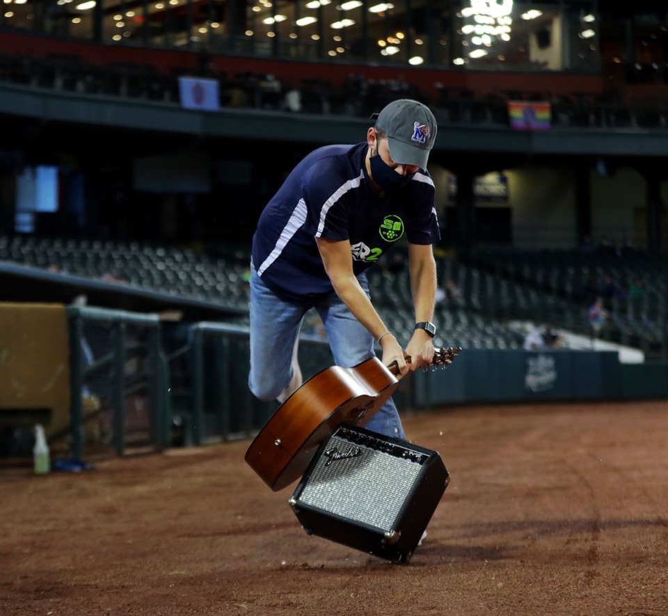 <strong>West Tennessee teacher of the year Daniel Warner smashes the ceremonial guitar during Memphis 901 FC's last home game of the year Oct. 3, 2020.</strong> (Patrick Lantrip/Daily Memphian)