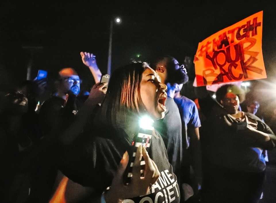 <strong>Theryn C. Bond (center) shouts at police during a protest on Wednesday, Sept. 19, in front of the Airways police precinct. Approximately 50 demonstrators gathered in front of the precinct to protest the actions of two police officers who turned off their body cameras prior to the shooting of an African-American man on Sept. 17.</strong> (Houston Cofield/Daily Memphian)