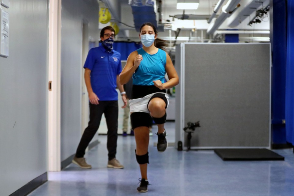 <strong>Daily Memphian reporter Danielle Lerner warms up under the watchful eye of Max Paquette at the University of Memphis Human Performance Center on Tuesday, Oct. 6.</strong> (Patrick Lantrip/Daily Memphian)