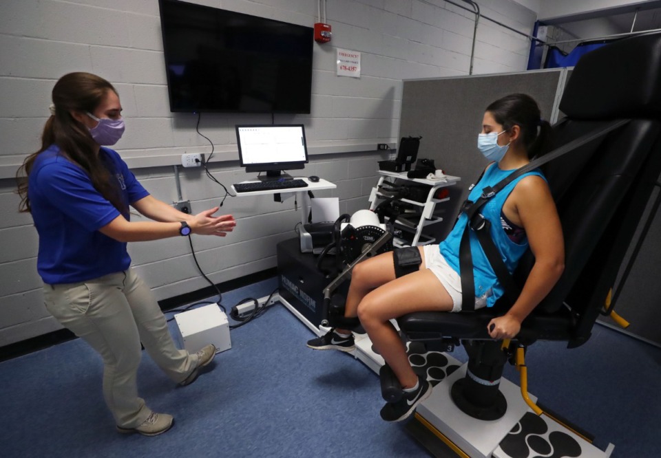 <strong>Daily Memphian reporter Danielle Lerner gets encouragement from Adriana Miltko while using the dynamometer at the University of Memphis Human Performance Center on Tuesday, Oct. 6.</strong> (Patrick Lantrip/Daily Memphian)