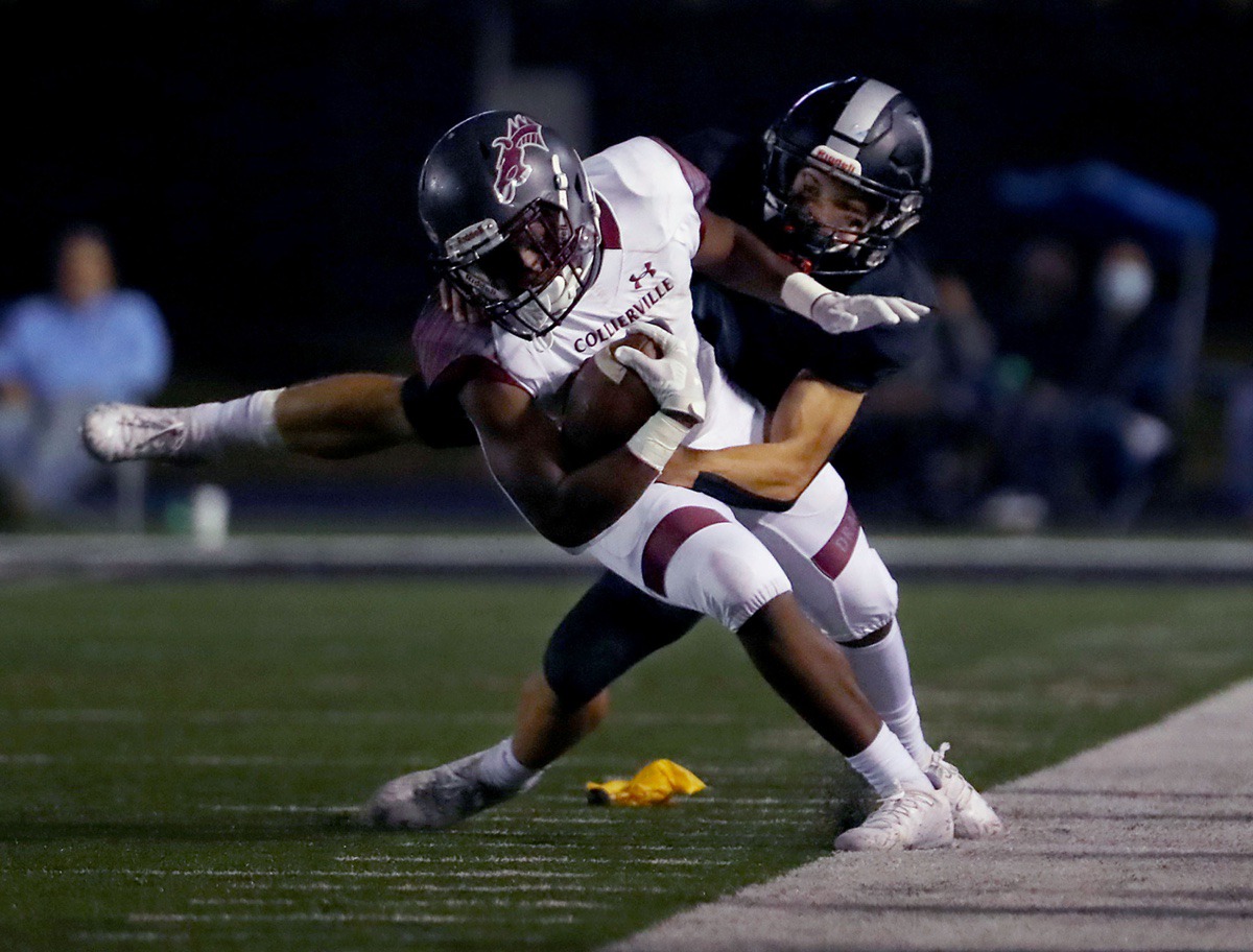 <strong>Collierville&rsquo;s John Hampton III (3) gets dragged out of bounds Oct. 9 by a Houston defender.</strong> (Patrick Lantrip/Daily Memphian)