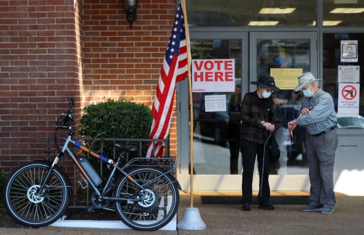 <strong>Stephanie and Frank Chalona check their watches after they leave the early voting location at Mississippi Boulevard Christian Church Oct. 14, 2020. The Chalonas waited in line for nearly an hour and a half.</strong> (Patrick Lantrip/Daily Memphian)