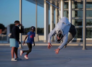 <strong>Tyjier Terrell with the Innovation Dance Company of Memphis does a flip while practicing a routine with Braylin Given (left) and Donovan Smith in the main plaza of the Raleigh Springs Civic Center on Friday, Oct. 16, 2020.</strong> (Patrick Lantrip/Daily Memphian)
