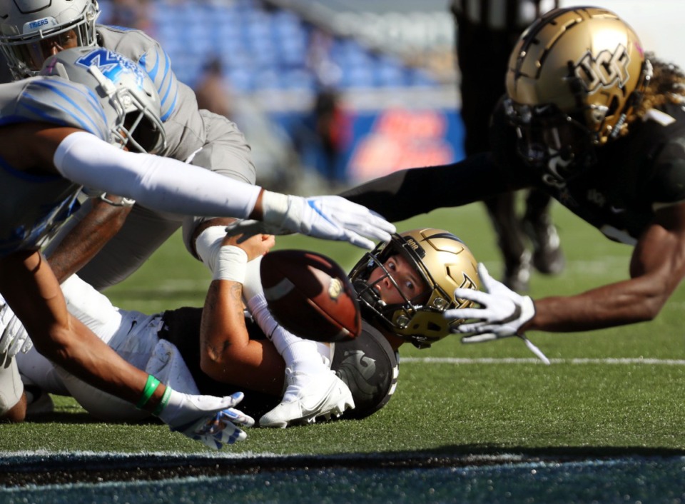 <strong>University of Central Florida quarterback Dillon Gabriel (11) watches a teammate fight for a loose ball during an Oct. 17, 2020 game against the University of Memphis at Liberty Bowl Memorial Stadium.</strong> (Patrick Lantrip/Daily Memphian)