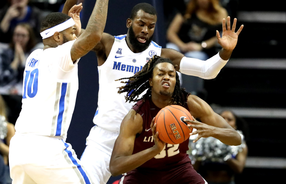 <strong>University of Memphis forwards Mike Parks Jr. (10) and Raynere Thornton (4) cover Little Rock Trojan forward Kris Bankston (32) as he attempts to pass during a&nbsp;</strong><span class="s1"><strong>game Wednesday, Dec. 19, 2018, at FedExForum in Memphis. </strong>(Houston Cofield/Daily Memphian)</span>
