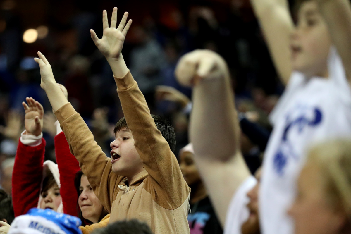 <strong>Fans at the University of Memphis basketball game against the Little Rock Trojans reach for t-shirts being shot out of a canon. The Tigers beat the Trojans 99-89 at FedExForum in Memphis on Wednesday, Dec. 19, 2018.</strong> (Houston Cofield/Daily Memphian)