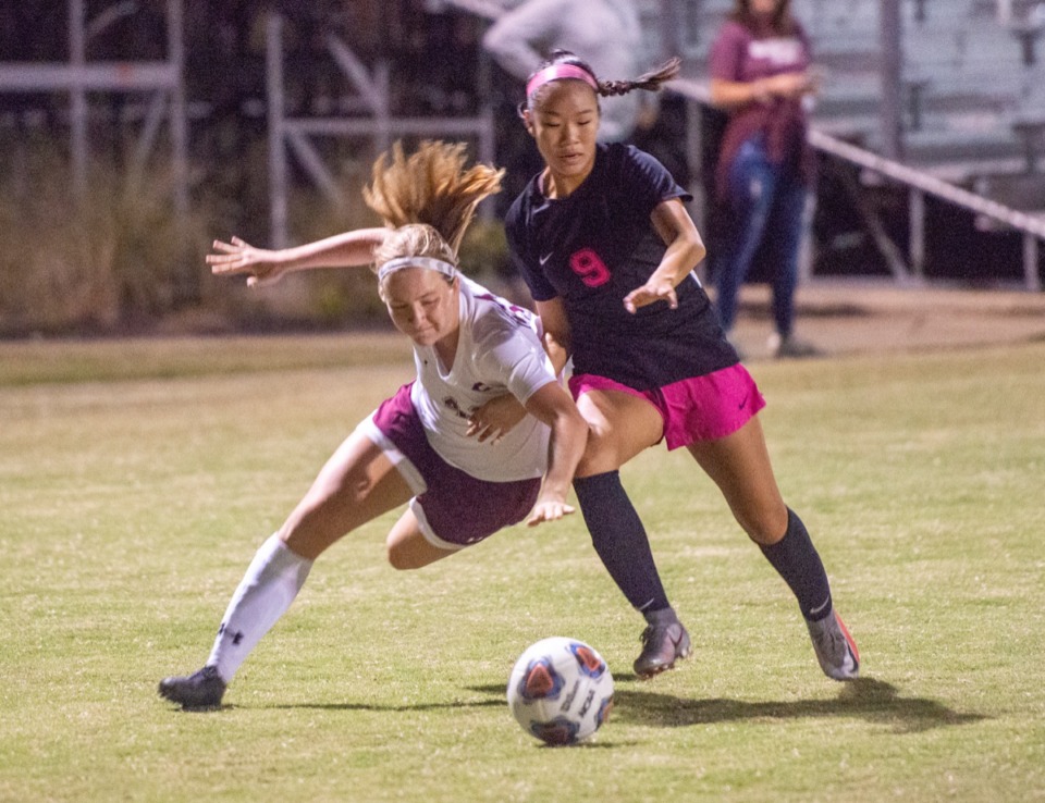<strong>Collierville High School's Ava Goodin keeps Houston High School's Lauren Fang from advancing the ball in the regional finals Tuesday, Oct. 20, 2020.</strong> (Greg Campbell/Special to The Daily Memphian)