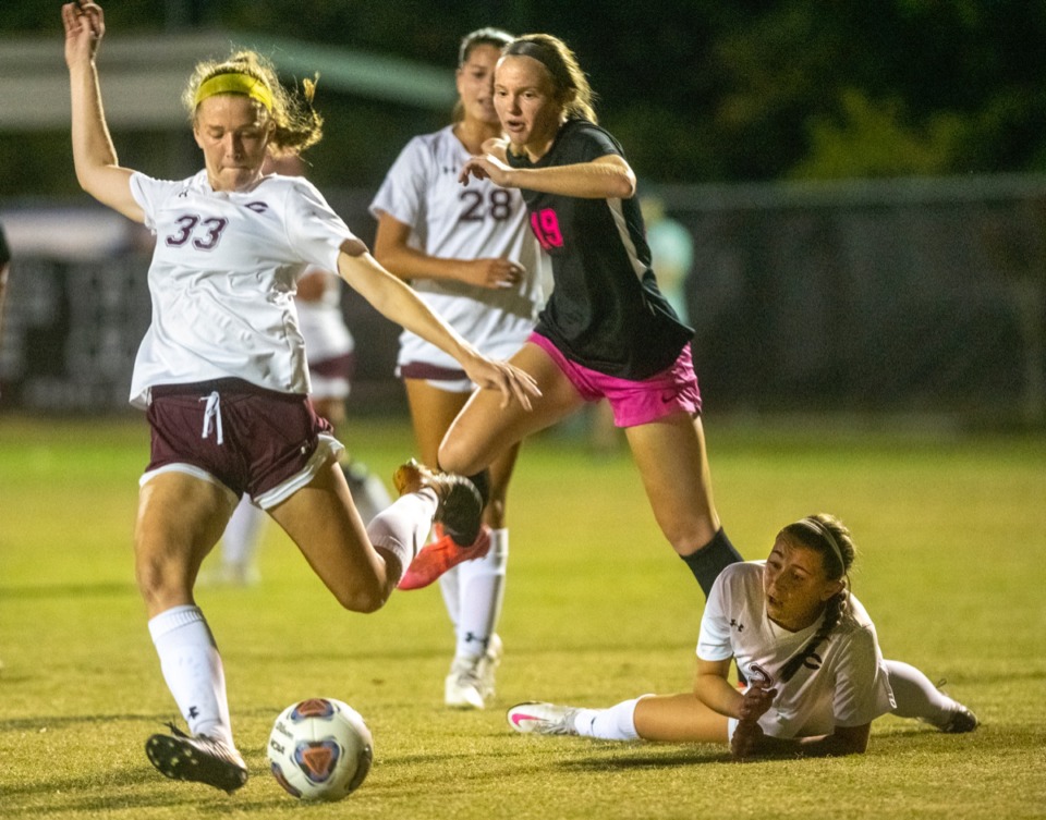 <strong>Collierville&rsquo;s Abby Johnson advances the ball against Houston&rsquo;s Emma Riales as Collierville's Reese Stimpson hits the turf at the regional finals Tuesday, Oct. 20, 2020, at Houston Middle School.</strong> (Greg Campbell/Special to The Daily Memphian)