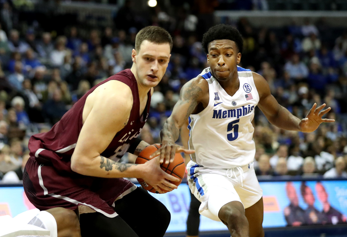 <strong>University of Memphis guard Kareem Brewton Jr. (5) swats the ball out of the hands of Little Rock Trojans forward Nikola Maric (55) during a game&nbsp;on Wednesday, Dec. 19, 2018, at FedExForum in Memphis.</strong> (Houston Cofield/Daily Memphian)