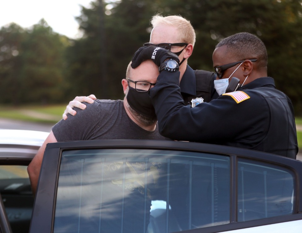 <strong>A protester gets detained by Memphis Police officers during a protest over an appearance by Attorney General William Barr at the Memphis Police Department Ridgeway Station Oct. 21, 2020.</strong> (Patrick Lantrip/Daily Memphian)