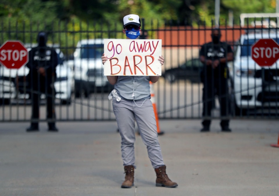 <strong>A protester holds a sign that reads "Go Away Barr" during a protest over an appearance by Attorney General William Barr at the Memphis Police Department Ridgeway Station Oct. 21, 2020.</strong> (Patrick Lantrip/Daily Memphian)