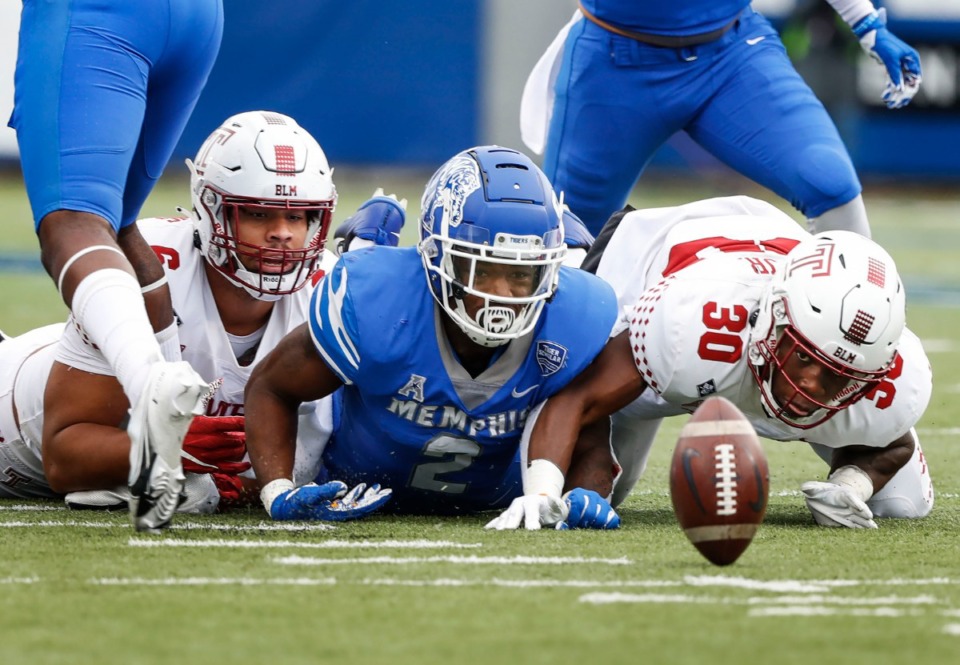 <strong>Memphis running back Rodrigues Clark (middle) watches a fumbled ball bounce away while flanked by Temple defenders Daniel Archibong (left) and Audley Isaacs (right) during action on Saturday, Oct. 24, 2020 at Liberty Bowl Memorial Stadium. Temple recovered the ball on the play.</strong> (Mark Weber/The Daily Memphian)