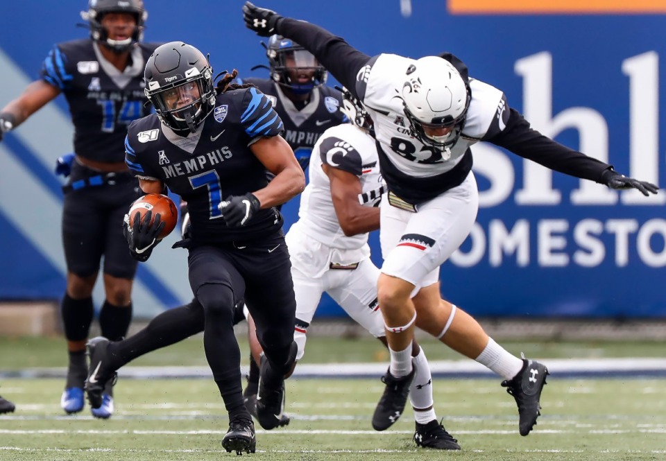 <strong>Memphis Tiger Chris Claybrooks (left) scrambles past the Cincinnati defense for a touchdown during action Friday, Nov. 29, 2019, at the Liberty Bowl Memorial Stadium. The Tigers and the Bearcats will play for the third time in 11 months on Halloween.</strong> (Mark Weber/Daily Memphian)