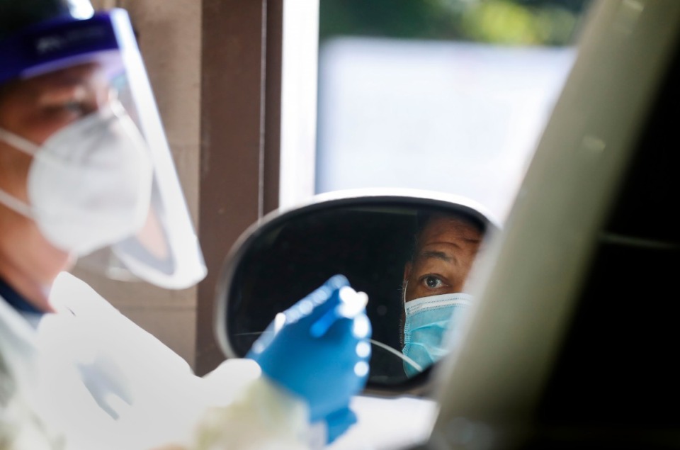 <strong>Christ Community Health Services staff members collect nasal swabs during at a drive-thru coronavirus testing site on Wednesday, Oct. 20, 2020 on Lamar Avenue.</strong> (Mark Weber/The Daily Memphian)