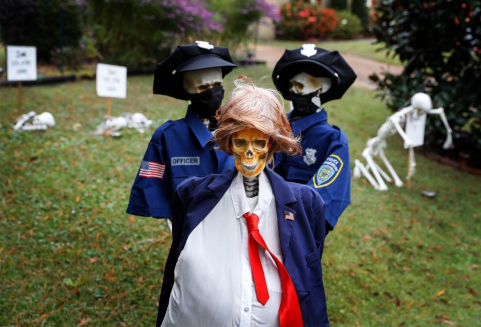 <strong>Skeletal &lsquo;police officers&rsquo; haul away a handcuffed skeleton dressed as Donald Tump in a lawn display at the home of Karen Derefinko and Matt Isaacs. &ldquo;We always do something creative,&rdquo; Karen said. &ldquo;Two years ago, the&nbsp;skeletons were playing volleyball. Last year, they were getting ready for Christmas, trying to put up the Christmas lights.&rdquo;</strong> (Mark Weber/The Daily Memphian)