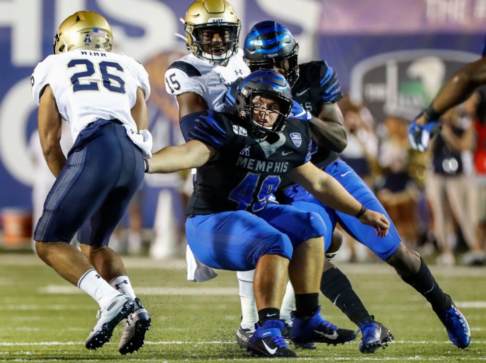 <strong>During last year&rsquo;s match at the Liberty Bowl Memorial Stadium, Navy punt returner Garrett Winn (left) runs past Memphis defender Treysen Neal (right)</strong>.&nbsp;<strong>The team announced that its Nov. 14 game at Navy will kick off at 2:30 p.m.</strong> (Mark Weber/Daily Memphian file)