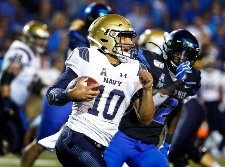 <strong>Navy quarterback Malcolm Perry looked for a lane against the Memphis defense at Liberty Bowl Memorial Stadium last year.</strong> (Mark Weber/Daily Memphian file)