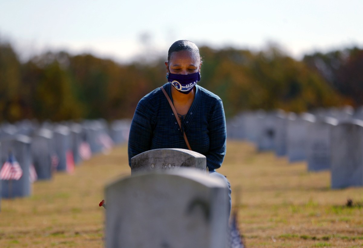 <strong>Carolyn Taylor pays her respects to her brother Rodney Taylor, who was a Navy Veteran, on Veterans Day at the West Tennessee State Veterans Cemetery Nov. 11, 2020</strong>. (Patrick Lantrip/Daily Memphian)