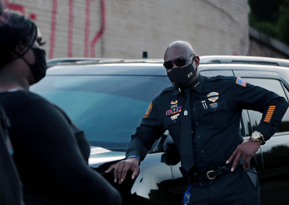 <strong>A Memphis police officer listens to protestors during an Aug. 26, 2020 protest held at the South Memphis Mapco where U.S. Marshals shot a 16-year-old in a case of mistaken identity.</strong> (Patrick Lantrip/Daily Memphian file)