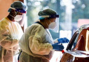 <strong>Christ Community Health Services staff members collect nasal swabs at a drive-thru coronavirus testing site in October on Lamar Avenue</strong>. (Mark Weber/The Daily Memphian)