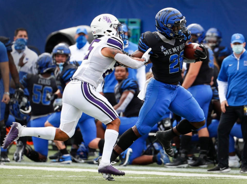 <strong>Memphis running back Marquavius Weaver (right) fights for a first down against Stephen F. Austin defender Tkai Lloyd (left) during action on Saturday, Nov. 21, 2020.</strong> (Mark Weber/The Daily Memphian)