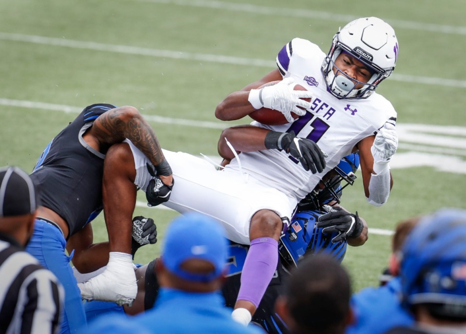 <strong>Stephen F. Austin receiver Jeremiah Miller (top) is taken down by the Memphis defense during action on Saturday, Nov. 21, 2020.</strong> (Mark Weber/The Daily Memphian)