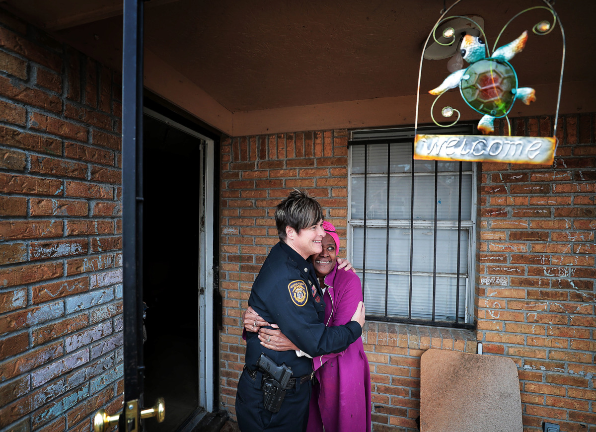 <strong>Burglary victim Sylvia Crump, 67, embraces Memphis Police Lt. Col. Dana Sampietro as Crump thanks officers and Boll Weevils who came to her house on Wednesday, Dec. 19, to replace Christmas gifts that were stolen from her home.</strong> (Jim Weber/Daily Memphian)